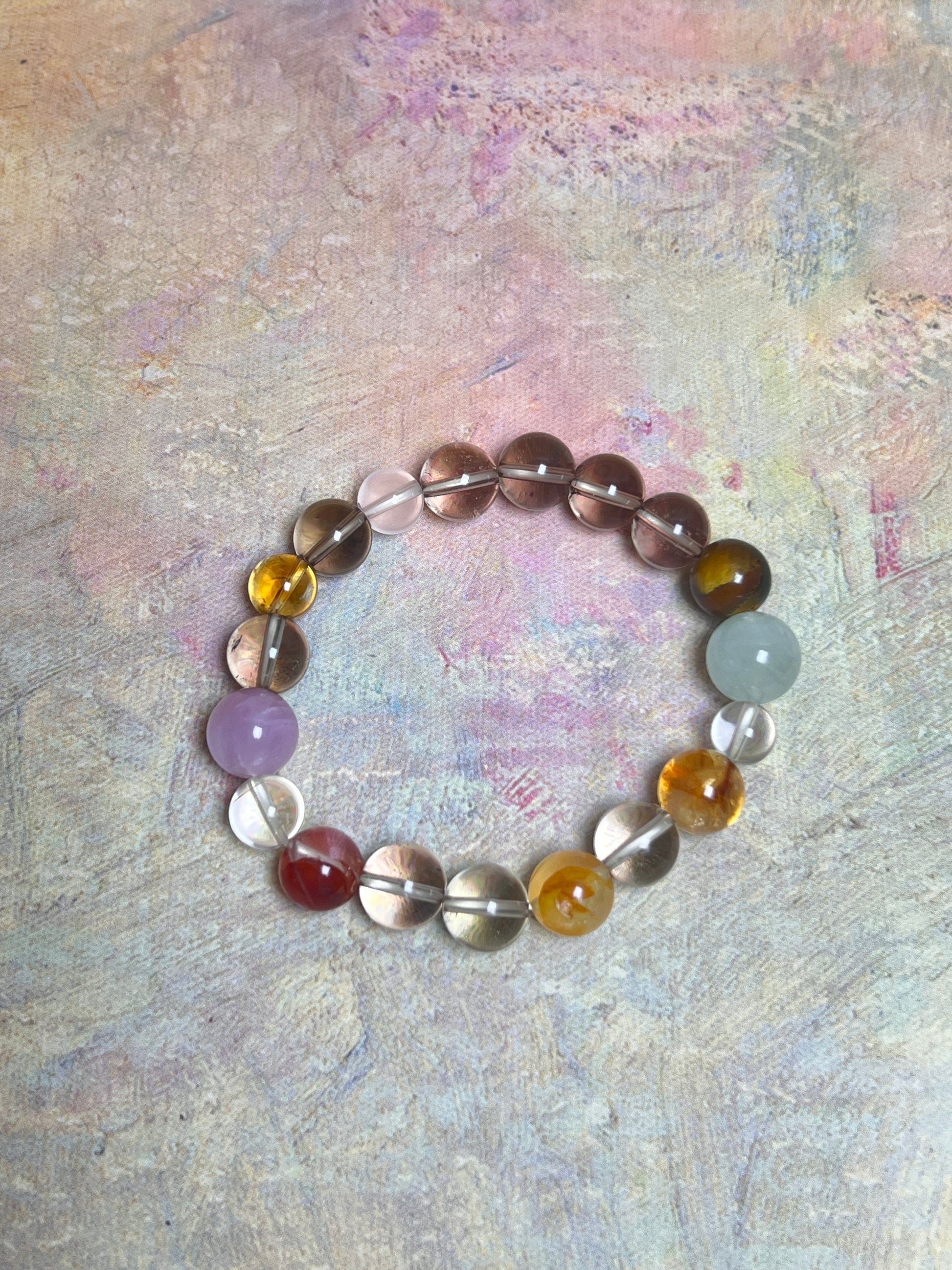 Multicolored beaded bracelet on a textured pastel background