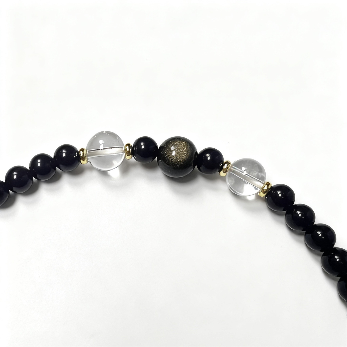 Close-up of obsidian, agate and clear quartz beads - Natural protection crystal bracelet detail
