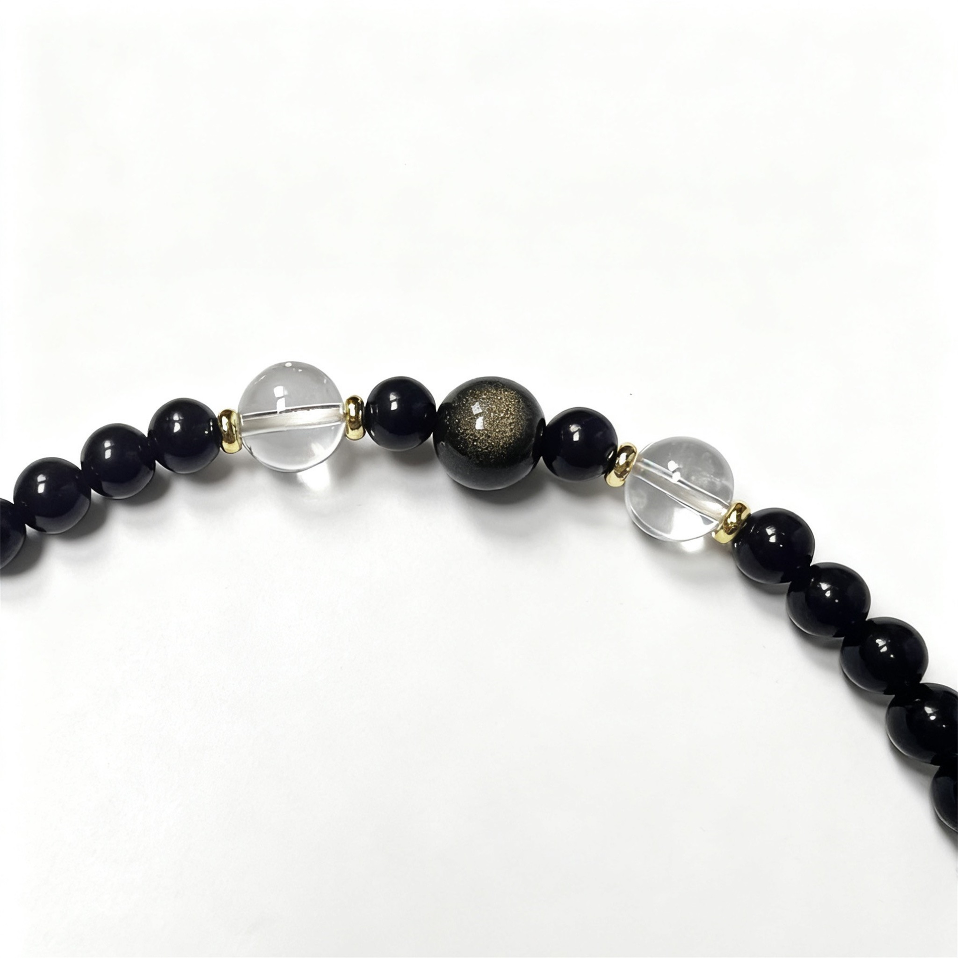 Close-up of obsidian, agate and clear quartz beads - Natural protection crystal bracelet detail
